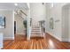 Bright and inviting foyer features hardwood floors, staircase, and arched doorway at 1300 Heritage Club Ave, Wake Forest, NC 27587