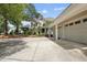 Home with landscaped front yard, detached garage, and large concrete driveway at 1300 Heritage Club Ave, Wake Forest, NC 27587