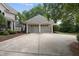 Detached two-car garage with neutral paint, shingled roof, and ample driveway space at 1300 Heritage Club Ave, Wake Forest, NC 27587