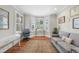 Comfortable home office featuring a cozy seating area, desk, and natural light at 1300 Heritage Club Ave, Wake Forest, NC 27587