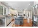 Spacious kitchen with hardwood floors, ample white cabinetry, stainless steel appliances, and a center island at 1300 Heritage Club Ave, Wake Forest, NC 27587