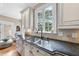 Stylish kitchen sink features granite countertops, tiled backsplash, stainless steel appliances and modern faucet at 1300 Heritage Club Ave, Wake Forest, NC 27587