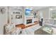 Beautiful living room featuring built-in shelving, hardwood floors, and a cozy fireplace at 1300 Heritage Club Ave, Wake Forest, NC 27587