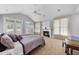 Spacious main bedroom features a fireplace, ceiling fan, carpet floors and large windows with great natural light at 1300 Heritage Club Ave, Wake Forest, NC 27587