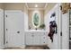 Mudroom featuring white wainscotting, storage cabinets, and a charming oval window at 1300 Heritage Club Ave, Wake Forest, NC 27587