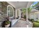 Covered patio with comfortable seating, perfect for enjoying the outdoors with a view of the well-manicured yard at 1300 Heritage Club Ave, Wake Forest, NC 27587