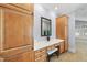 Stylish vanity area with built-in cabinetry and ample lighting at 1300 Heritage Club Ave, Wake Forest, NC 27587