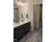 Bathroom featuring gray wood-look tile, double vanity, and a glass enclosed walk-in shower at 1357 Prevenient Dr, Wake Forest, NC 27587