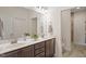 Bright bathroom featuring double sink vanity, framed mirror, and walk-in shower at 1357 Prevenient Dr, Wake Forest, NC 27587