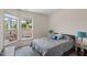 Well-lit bedroom featuring a cozy bed and view to outdoor patio at 1357 Prevenient Dr, Wake Forest, NC 27587