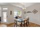 Dining area with wood floors, decorative artwork, and large window offering natural light and views at 1357 Prevenient Dr, Wake Forest, NC 27587
