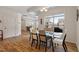 Well-lit dining area featuring wood floors and a large window overlooking the backyard at 1357 Prevenient Dr, Wake Forest, NC 27587
