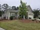 Well-maintained home with lush green lawn, stone accents, and a welcoming front porch area at 1357 Prevenient Dr, Wake Forest, NC 27587