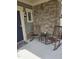 Cozy front porch with stone detailing, rocking chairs, and a welcoming entrance at 1357 Prevenient Dr, Wake Forest, NC 27587