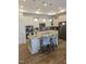 Modern kitchen featuring a granite island with bar seating, white cabinets, and stainless steel appliances at 1357 Prevenient Dr, Wake Forest, NC 27587