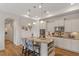 Spacious kitchen with white cabinets, granite counters, stainless appliances, and a central island with seating at 1357 Prevenient Dr, Wake Forest, NC 27587