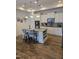 Modern kitchen featuring a granite island with bar seating, white cabinets, and stainless steel appliances at 1357 Prevenient Dr, Wake Forest, NC 27587