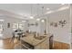 Open concept kitchen with granite counters, island seating, and seamless flow to the dining area at 1357 Prevenient Dr, Wake Forest, NC 27587