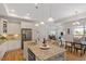 Open kitchen with island, granite countertops, stainless steel appliances, and access to the dining area at 1357 Prevenient Dr, Wake Forest, NC 27587