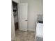 Spacious laundry area with storage shelves, utility door, ironing board, and modern appliances at 1357 Prevenient Dr, Wake Forest, NC 27587