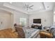 Cozy living room features modern ceiling fan, tray ceiling, and wood-look flooring at 1357 Prevenient Dr, Wake Forest, NC 27587