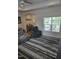 Bright living room showcasing a large window, cozy seating, stylish rug, and an inviting atmosphere at 1357 Prevenient Dr, Wake Forest, NC 27587