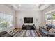 Bright living room boasts tray ceilings, large windows, and neutral walls at 1357 Prevenient Dr, Wake Forest, NC 27587