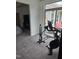 Open-concept living room with exercise equipment and sliding doors to the patio at 1357 Prevenient Dr, Wake Forest, NC 27587