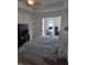Neutral main bedroom with tray ceilings, large bed, and workout/office area at 1357 Prevenient Dr, Wake Forest, NC 27587