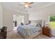 Main bedroom with tray ceiling, nightstands, and large windows at 1357 Prevenient Dr, Wake Forest, NC 27587