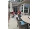 Charming patio with outdoor seating, a fire pit, and a grill, complemented by a well-maintained backyard at 1357 Prevenient Dr, Wake Forest, NC 27587