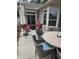 Outdoor patio area with table, chairs, accent furniture, and an umbrella, perfect for relaxing and entertaining guests at 1357 Prevenient Dr, Wake Forest, NC 27587