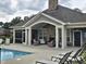 An inviting poolside clubhouse with fireplace and seating, perfect for relaxing at 1357 Prevenient Dr, Wake Forest, NC 27587