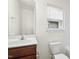 Bathroom with vanity and toilet under a window at 1506 Golden Bell Dr, Raleigh, NC 27610