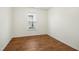 Well-lit bedroom with neutral walls and hardwood floors at 1506 Golden Bell Dr, Raleigh, NC 27610