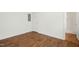 Bedroom with wood floors and bright white paint and views to the doorway and hallway at 1506 Golden Bell Dr, Raleigh, NC 27610