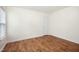 Bright bedroom with hardwood floors and door at 1506 Golden Bell Dr, Raleigh, NC 27610