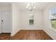 Bright dining room featuring hardwood floors and a stylish chandelier at 1506 Golden Bell Dr, Raleigh, NC 27610