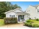 Quaint single Gathering home showcasing manicured lawn and covered porch with seating at 1506 Golden Bell Dr, Raleigh, NC 27610