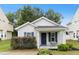 Charming single-story home with blue shutters and a cozy front porch seating area at 1506 Golden Bell Dr, Raleigh, NC 27610
