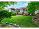 Expansive backyard with a lush lawn, mature trees, and a screened porch visible on the house at 1577 Tice Hurst Ln, Apex, NC 27502