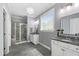 Elegant bathroom featuring double vanities, a glass-enclosed shower, and modern fixtures at 1577 Tice Hurst Ln, Apex, NC 27502