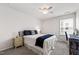 Bedroom featuring ceiling fan, white walls, and large window at 1577 Tice Hurst Ln, Apex, NC 27502