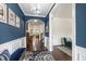 Elegant foyer featuring hardwood floors, wainscoting, and an open floor plan at 1577 Tice Hurst Ln, Apex, NC 27502