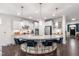 Bright kitchen with granite island, pendant lighting, stainless appliances, and seating for four at 1577 Tice Hurst Ln, Apex, NC 27502
