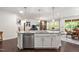 Spacious kitchen island with granite countertops and views of the living room at 1577 Tice Hurst Ln, Apex, NC 27502