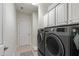 Functional laundry room with modern washer and dryer, and ample storage space at 1577 Tice Hurst Ln, Apex, NC 27502