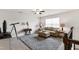 Upstairs sitting area featuring sofa, ceiling fan, and table at 1577 Tice Hurst Ln, Apex, NC 27502