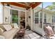 Relaxing screened porch with plush seating, woven rug, and view to the kitchen through sliding glass doors at 1577 Tice Hurst Ln, Apex, NC 27502