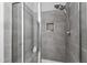 Modern tiled shower with glass enclosure and rainfall shower head at 1577 Tice Hurst Ln, Apex, NC 27502